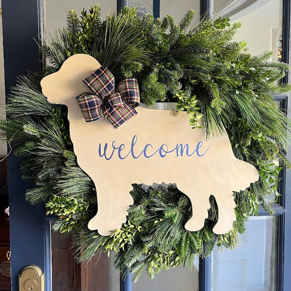 three spoiled dogs customizable golden retriever welcome door hanger with a blue plaid bow on a wreath hanging on a front door