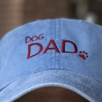 three spoiled dogs blue baseball cap with dog dad embroidered in red thread with  a paw print